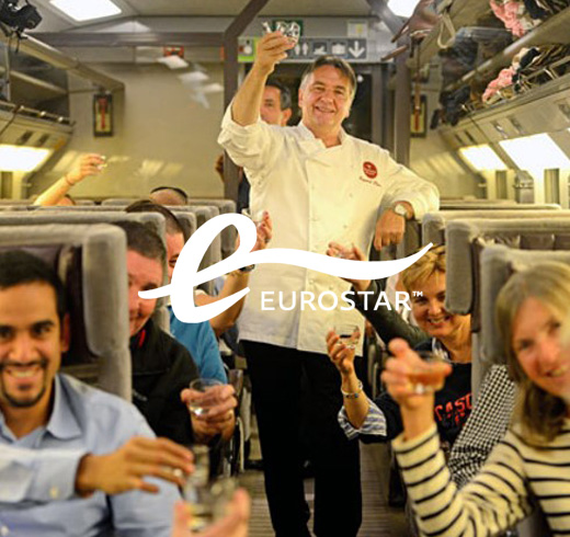 Eurostar logo in front of people on train