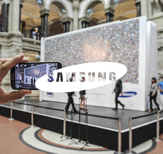 samsung logo on top of person taking picture with samsung phone