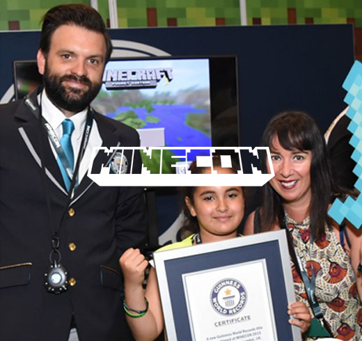Minecon logo in front of adjudicator next to girl and woman holding gwr certificate