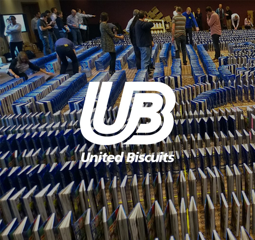 United Biscuits logo next to people using books as dominos 