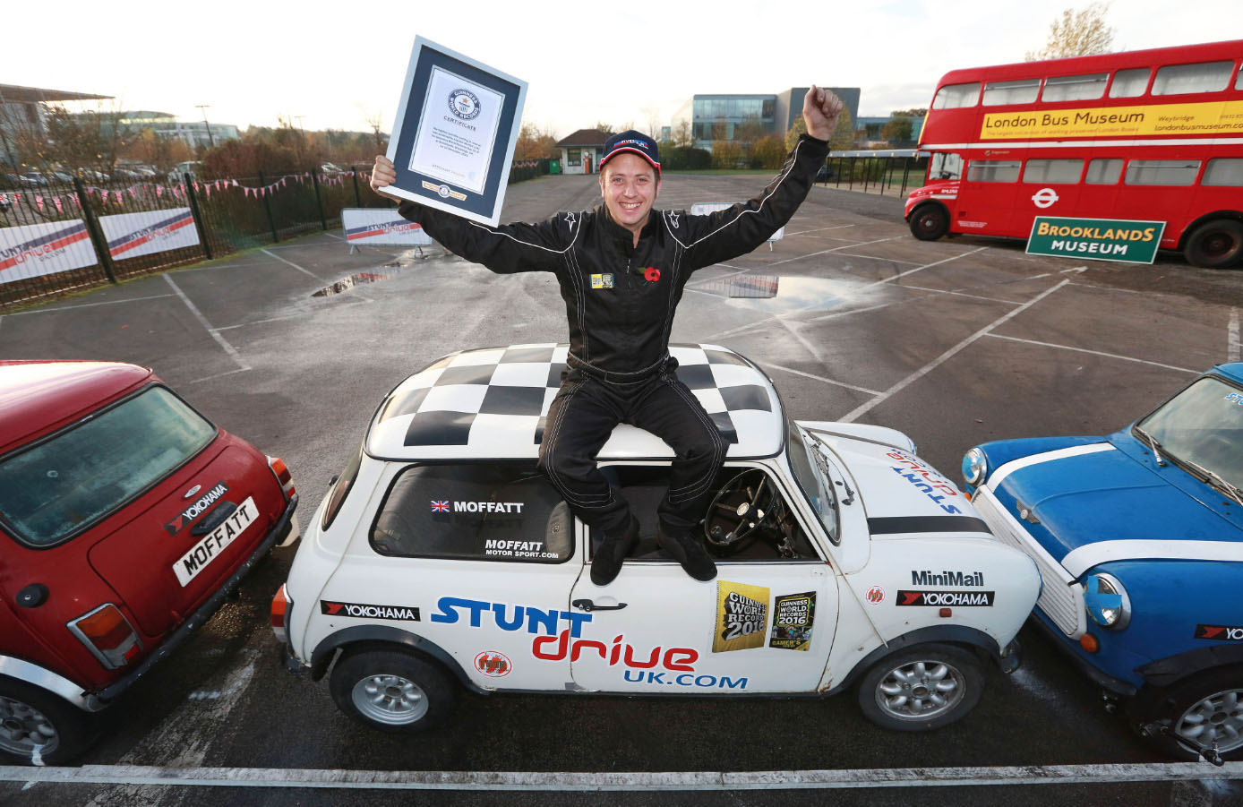man on top of hite car holding gwr certificate